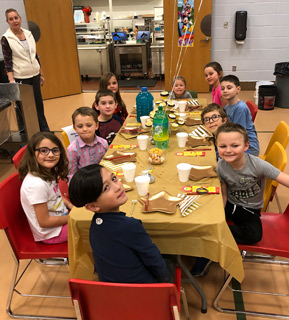 Students eating at a decorated table